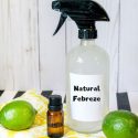 spray bottle with a label that reads "natural febreeze" and limes and essential oils on a cloth