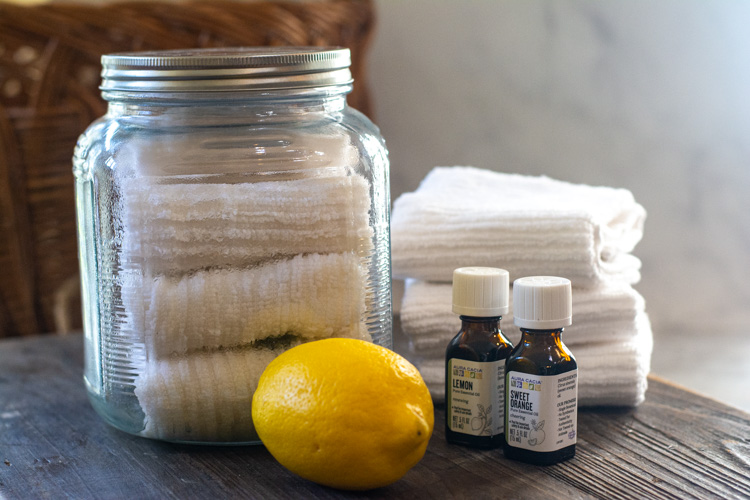 ingredients for reusable wipes including lemon and cloth rages in a glass jar